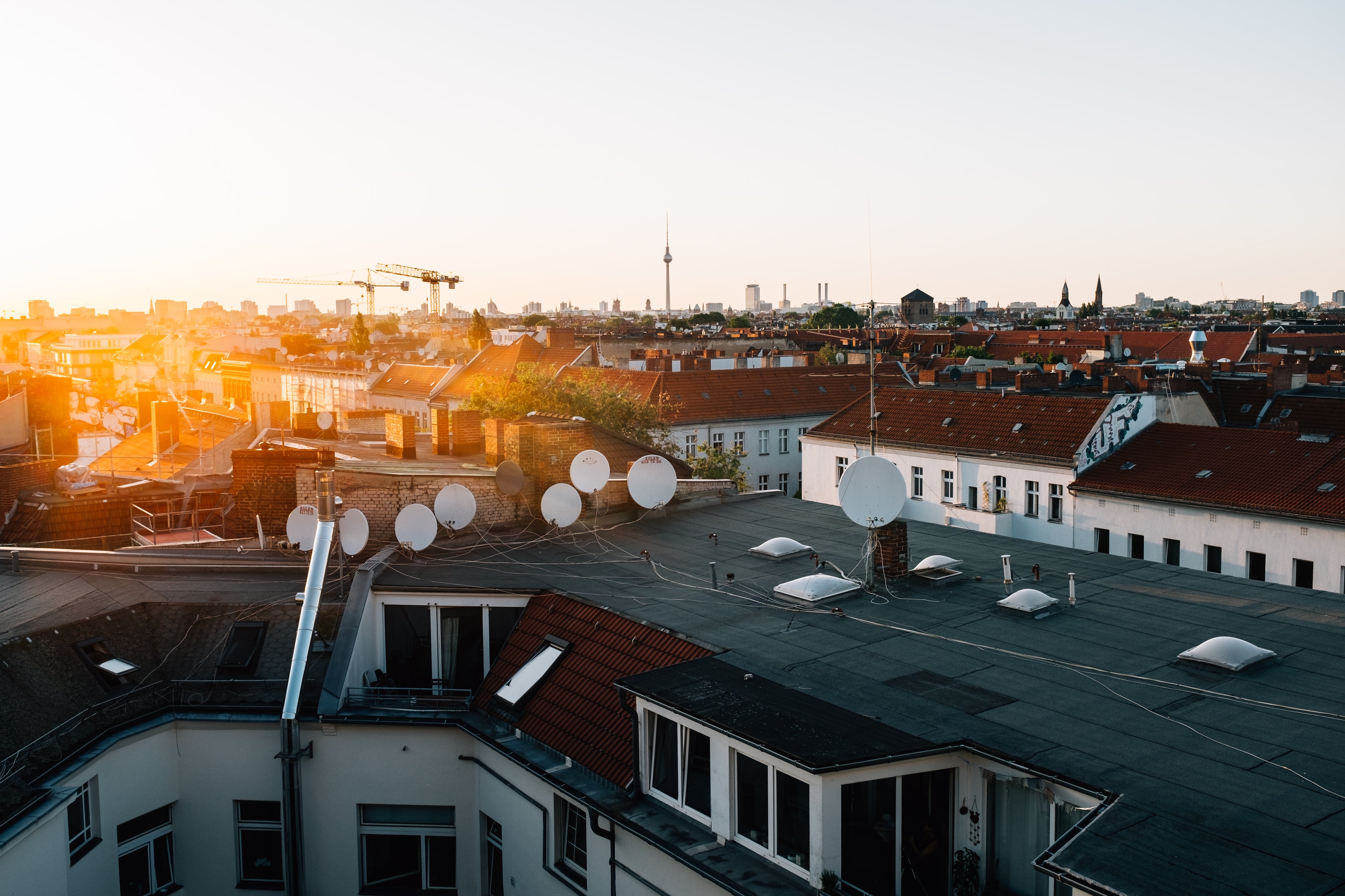 sunset-over-roof-topped-with-satellites.jpg